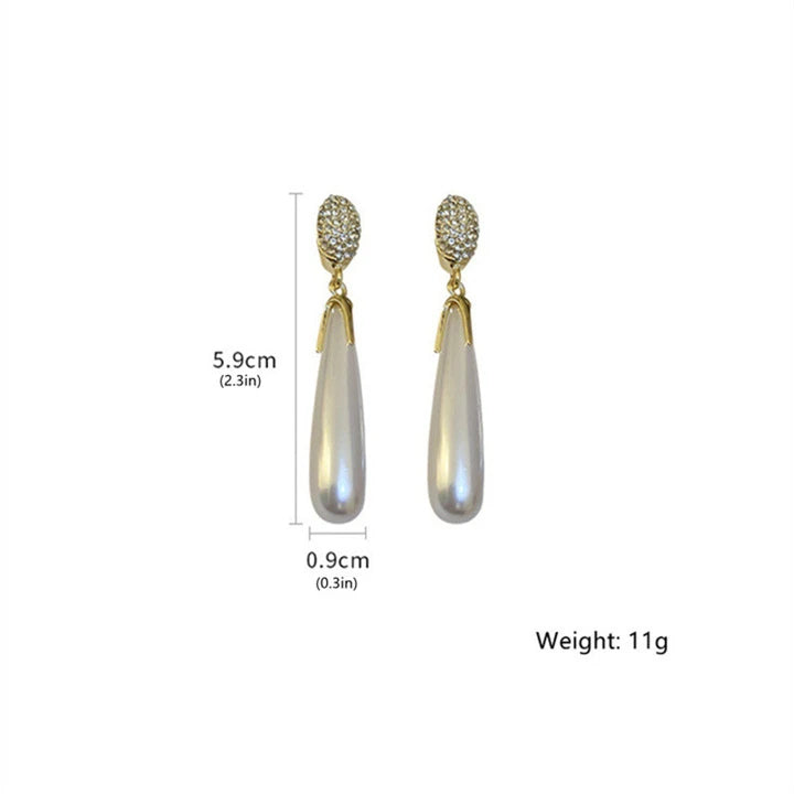 Aretes dorados de perla larga
